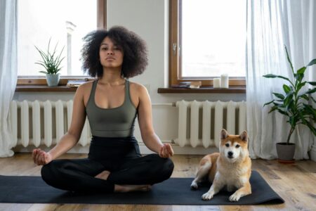 donna che fa yoga con cane
