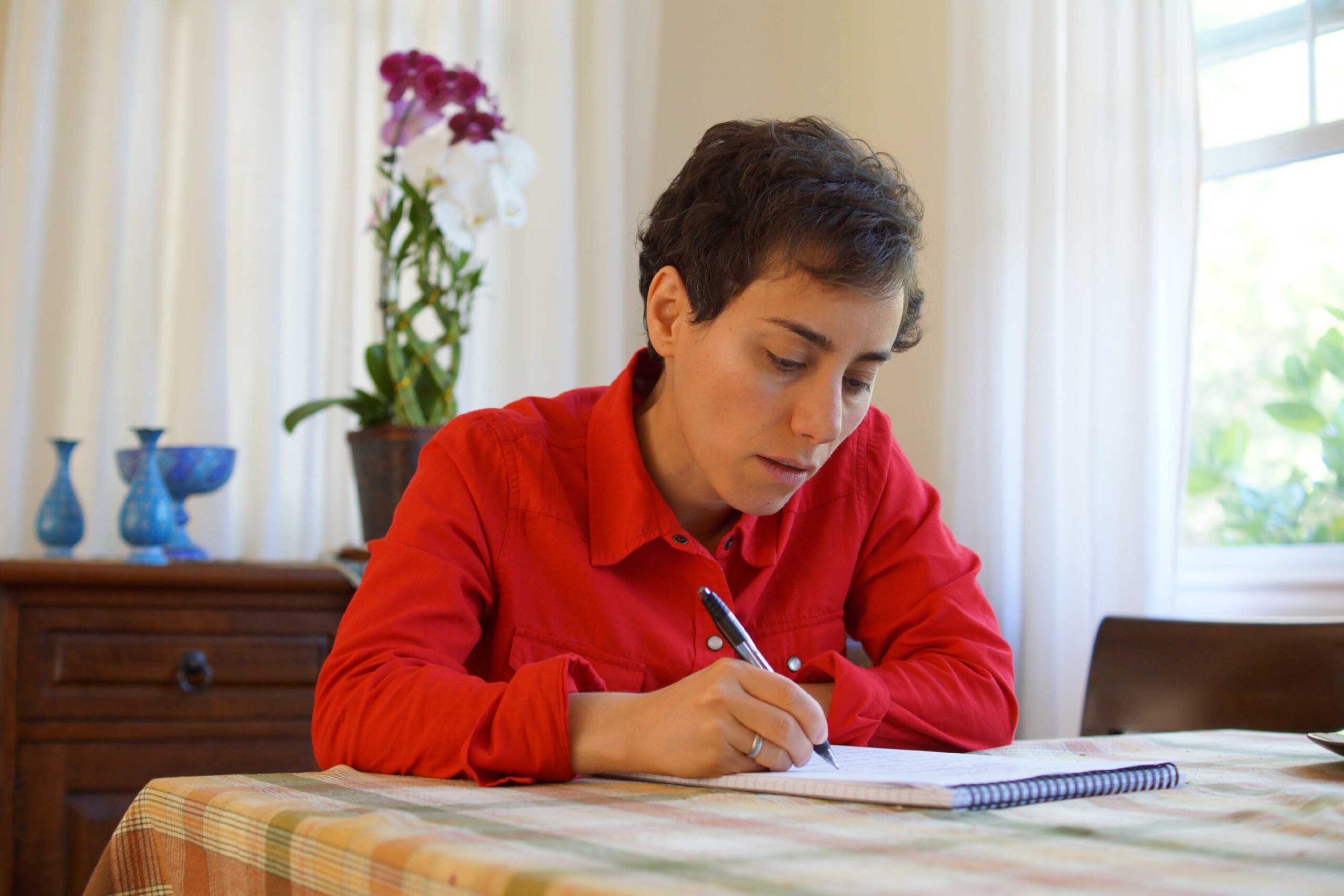 Maryam Mirzakhani mentre scrive