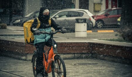 Un rider di Glovo effettua una consegna durante una nevicata
